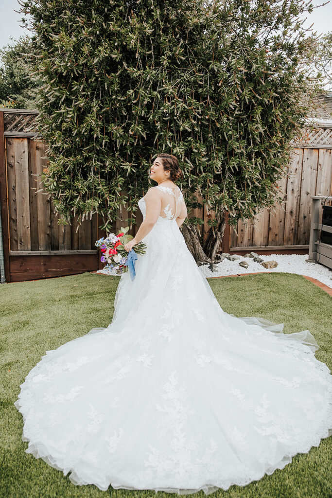 Image of a woman in an illusion wedding dress with a long train. Ines by Pronovias Privee.