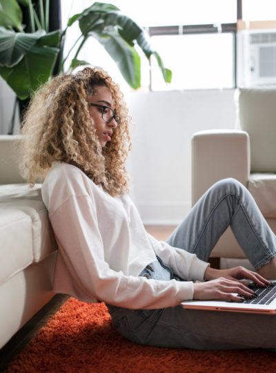 Woman on her laptop computer in a remote meeting.